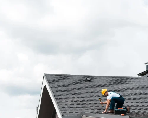 roofer-repairing-roof-with-hammer-and-toolbox-2026-03-13-01-10-50-utc