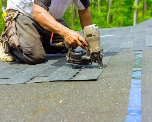 worker-installing-roofing-shingles-with-nail-gun-2026-03-24-23-53-47-utc